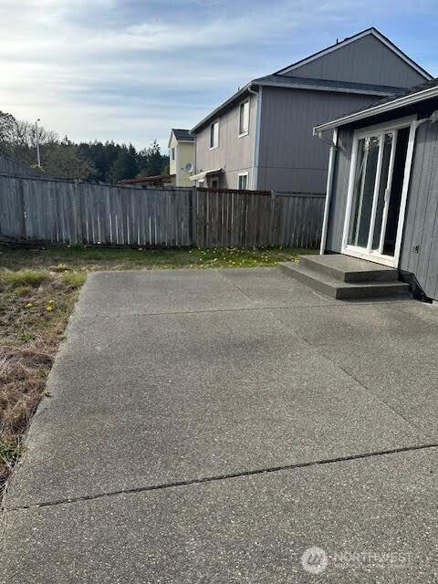 view of patio featuring fence
