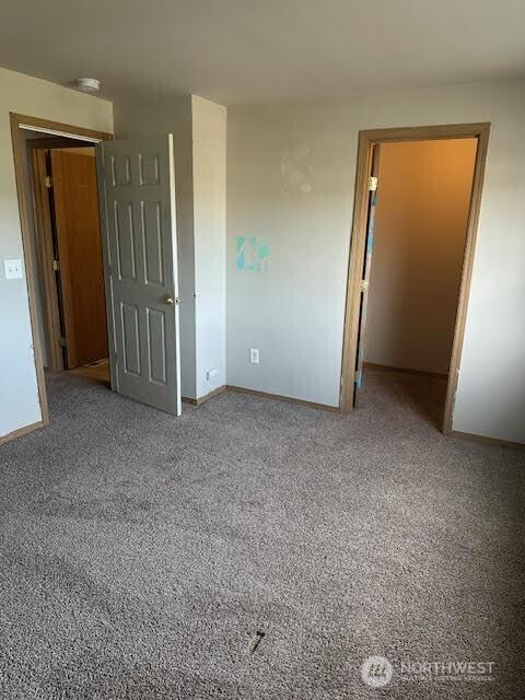 unfurnished bedroom with baseboards and carpet floors