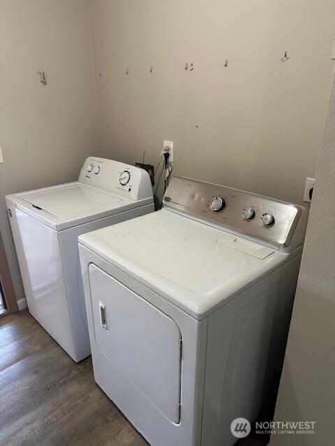 laundry room featuring laundry area, washer and clothes dryer, and wood finished floors