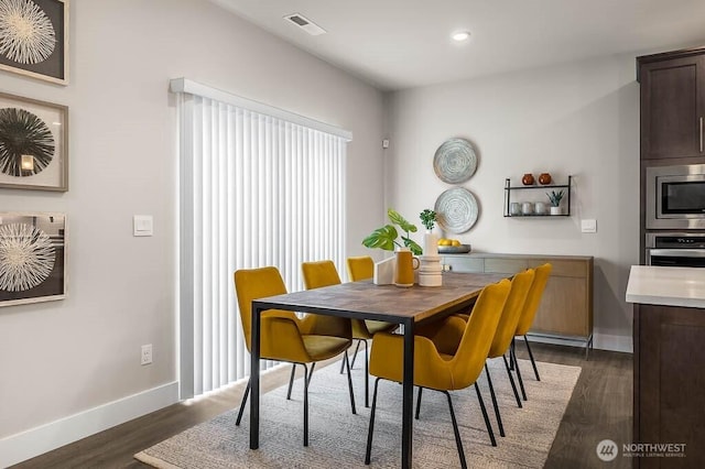 dining area with baseboards, dark wood finished floors, recessed lighting, and visible vents