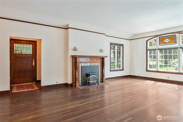 1639 21st Ave, Longview, WA 98632 - unfurnished living room featuring a wood stove, wood finished floors, and baseboards