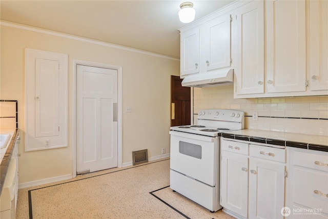 1639 21st Ave, Longview, WA 98632 - kitchen featuring white range with electric stovetop, under cabinet range hood, tile countertops, white cabinets, and baseboards