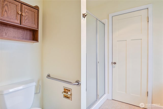 1639 21st Ave, Longview, WA 98632 - bathroom featuring a shower stall, toilet, and tile patterned floors