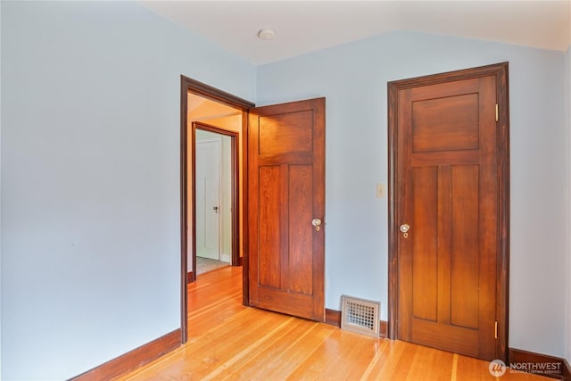 1639 21st Ave, Longview, WA 98632 - unfurnished bedroom featuring light wood-style flooring, vaulted ceiling, and baseboards