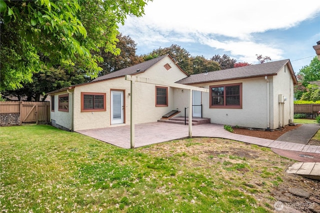 1639 21st Ave, Longview, WA 98632 - back of property featuring a patio area, stucco siding, and a gate