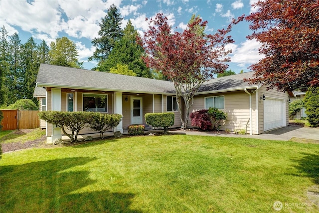 single story home with fence, an attached garage, concrete driveway, a front yard, and a shingled roof