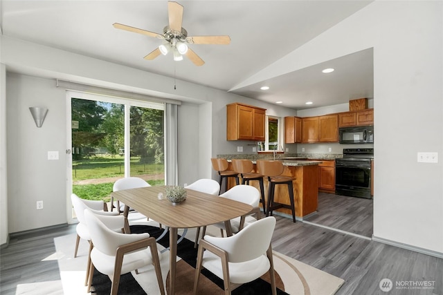 dining room with light wood-style flooring, recessed lighting, baseboards, ceiling fan, and vaulted ceiling
