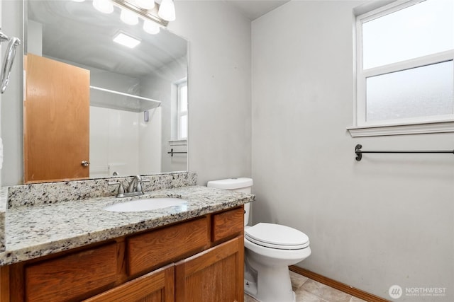 full bathroom with a shower, a healthy amount of sunlight, vanity, and toilet