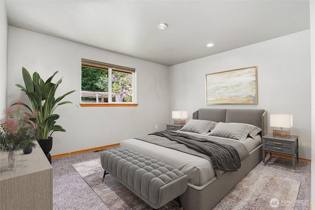 carpeted bedroom featuring baseboards and recessed lighting