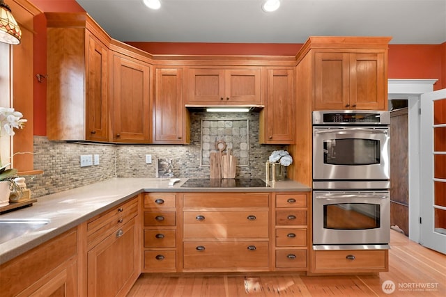 2234 Main St, Ferndale, WA 98248 - kitchen featuring double oven, black electric stovetop, decorative backsplash, light wood-style flooring, and recessed lighting