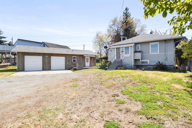 219 W 15th St, Port Angeles, WA 98362 - ranch-style house featuring dirt driveway, a garage, and board and batten siding