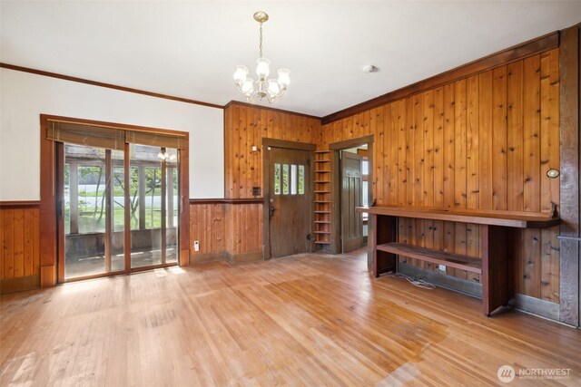 219 W 15th St, Port Angeles, WA 98362 - interior space featuring light wood-style floors, wood walls, a chandelier, and crown molding