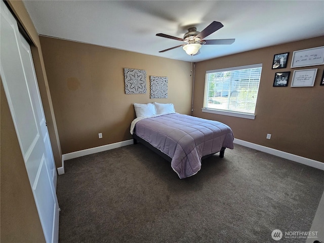 carpeted bedroom featuring a closet, baseboards, and a ceiling fan
