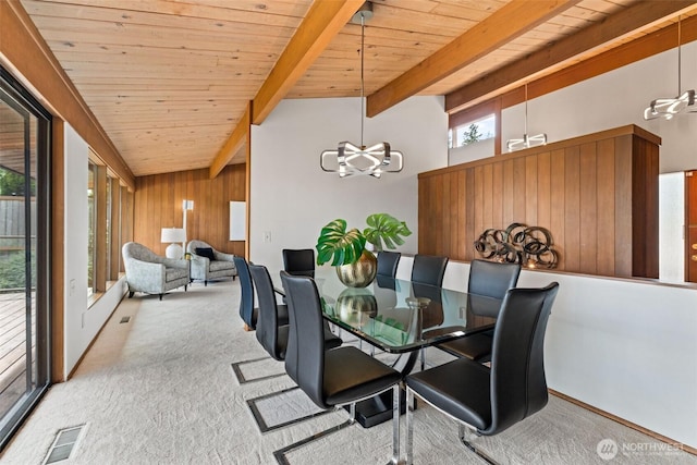 517 S 212th St, Des Moines, WA 98198 - carpeted dining room featuring wood ceiling, healthy amount of natural light, wooden walls, beamed ceiling, and a chandelier