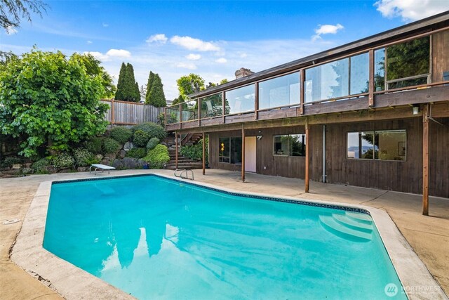 517 S 212th St, Des Moines, WA 98198 - view of swimming pool with stairs, a patio, a diving board, a wooden deck, and fence