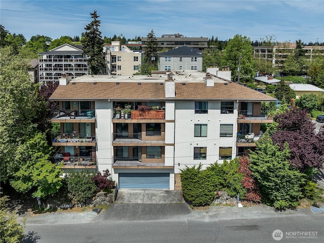 10601 Bagley Ave N Unit 204, Seattle, WA 98133 - view of apartment building / complex featuring an attached garage and driveway