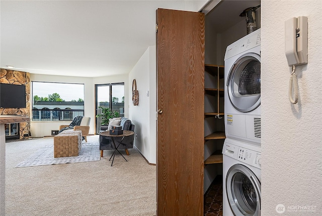 10601 Bagley Ave N Unit 204, Seattle, WA 98133 - washroom with estacked washer and dryer and carpet flooring