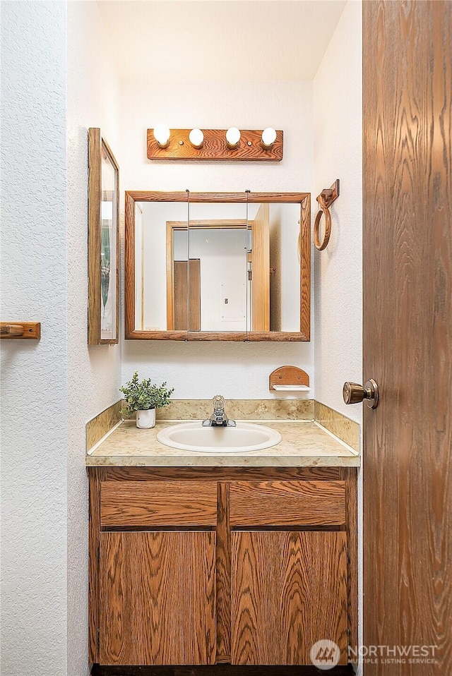 10601 Bagley Ave N Unit 204, Seattle, WA 98133 - bathroom featuring a textured wall and vanity