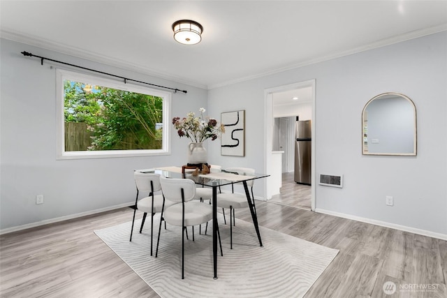 624 S Lawrence St, Tacoma, WA 98405 - dining room featuring light wood-style flooring, ornamental molding, and baseboards