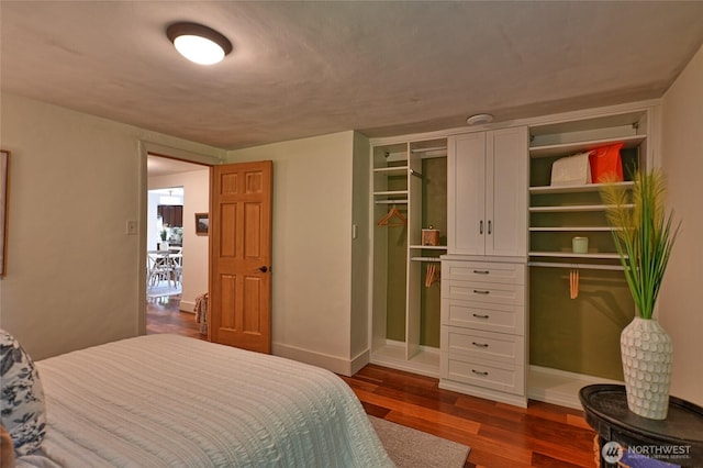 10733 14th Ave NE, Seattle, WA 98125 - bedroom with dark wood-type flooring, baseboards, and a closet