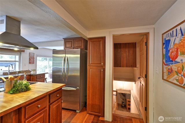 10733 14th Ave NE, Seattle, WA 98125 - kitchen featuring freestanding refrigerator, butcher block countertops, wood finished floors, and brown cabinetry