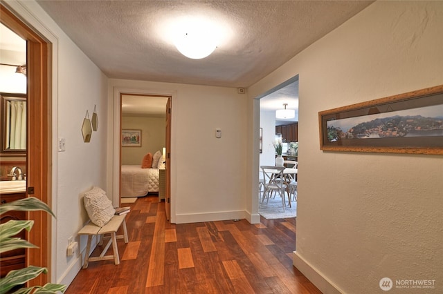 10733 14th Ave NE, Seattle, WA 98125 - corridor featuring dark wood finished floors, baseboards, and a textured ceiling