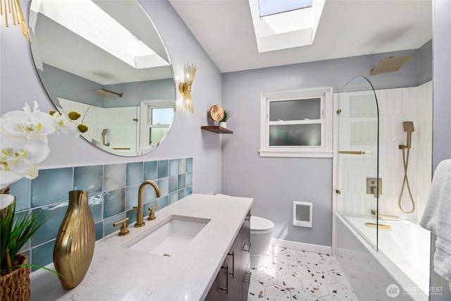 2537 Montavista Pl W, Seattle, WA 98199 - bathroom featuring a skylight, baseboards, vanity, heating unit, and bathtub / shower combination