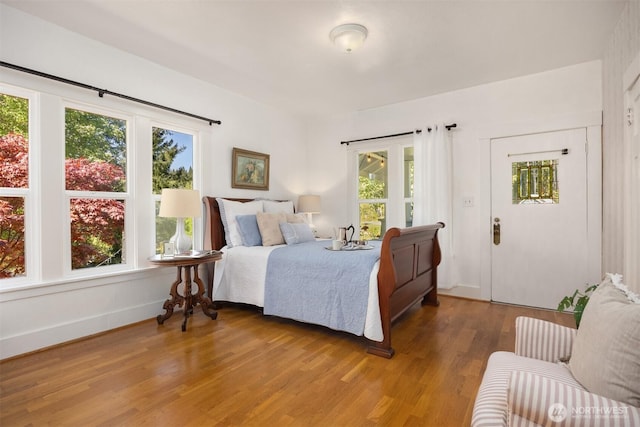 bedroom featuring baseboards and wood finished floors