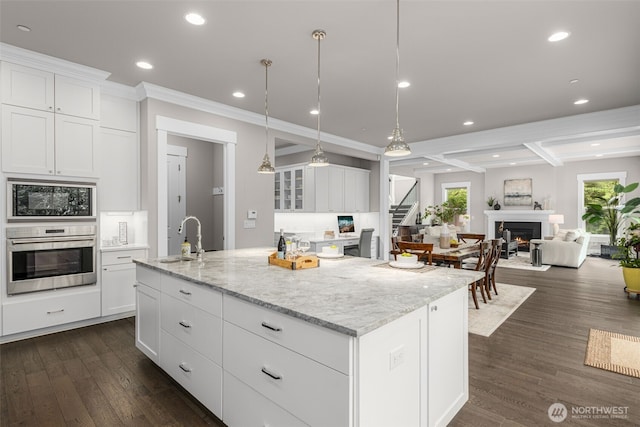 4161 86th Ave SE, Mercer Island, WA 98040 - kitchen featuring stainless steel oven, a sink, built in microwave, an island with sink, and healthy amount of natural light