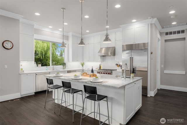 4161 86th Ave SE, Mercer Island, WA 98040 - kitchen featuring stainless steel appliances, under cabinet range hood, a center island, white cabinetry, and crown molding