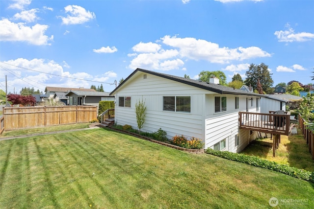rear view of property featuring a deck