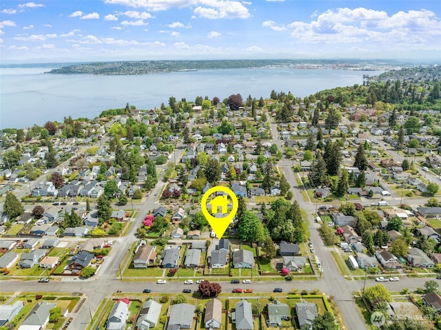 view of property location featuring a large body of water and nearby suburban area