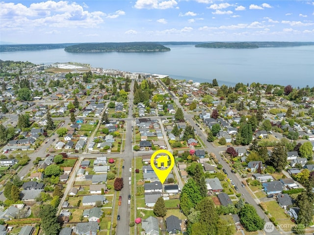 view of property location with a nearby body of water and nearby suburban area