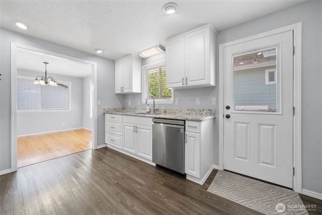 kitchen featuring dishwasher, a sink, dark wood-type flooring, and white cabinets