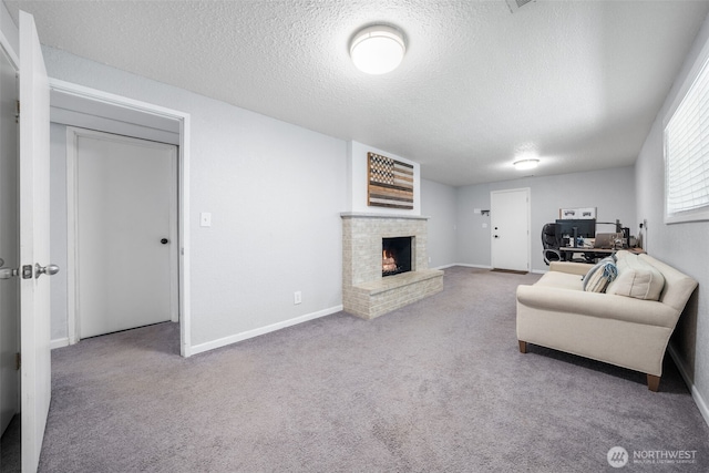living room with a fireplace, carpet, a textured ceiling, and baseboards