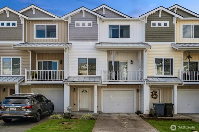 5305 Military Rd E Unit D, Tacoma, WA 98446 - view of property featuring a standing seam roof, an attached garage, and driveway