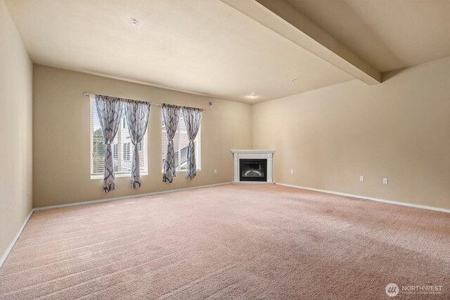 5305 Military Rd E Unit D, Tacoma, WA 98446 - unfurnished living room featuring carpet flooring, a glass covered fireplace, baseboards, and beamed ceiling