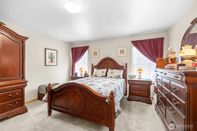bedroom with multiple windows and light carpet