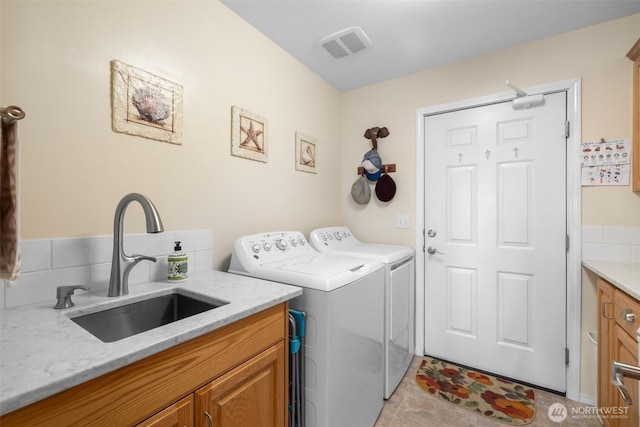 laundry room with washer and clothes dryer and cabinet space