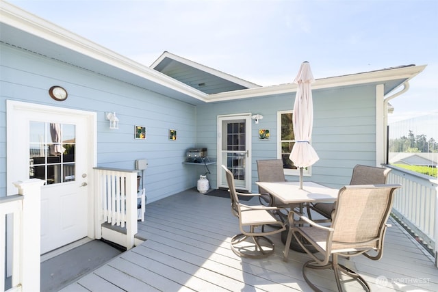 wooden terrace with outdoor dining area