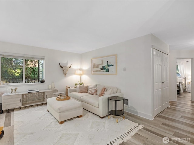 455 Newport Way NW Unit 302, Issaquah, WA 98027 - living room featuring light wood-style flooring and baseboards