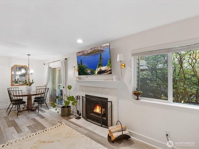 455 Newport Way NW Unit 302, Issaquah, WA 98027 - living area featuring a fireplace, healthy amount of natural light, wood finished floors, baseboards, and recessed lighting