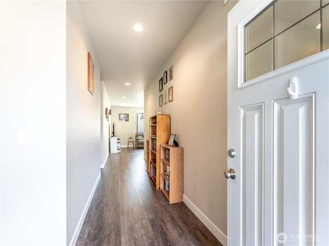 corridor with dark wood finished floors, baseboards, and recessed lighting