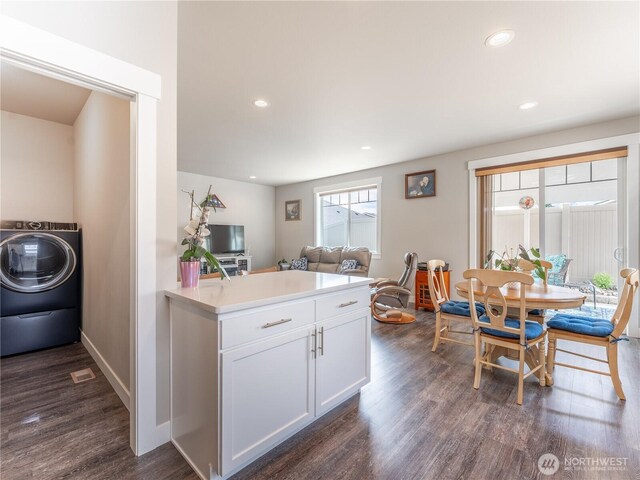 kitchen with washer / dryer, dark wood-style floors, white cabinets, light countertops, and recessed lighting