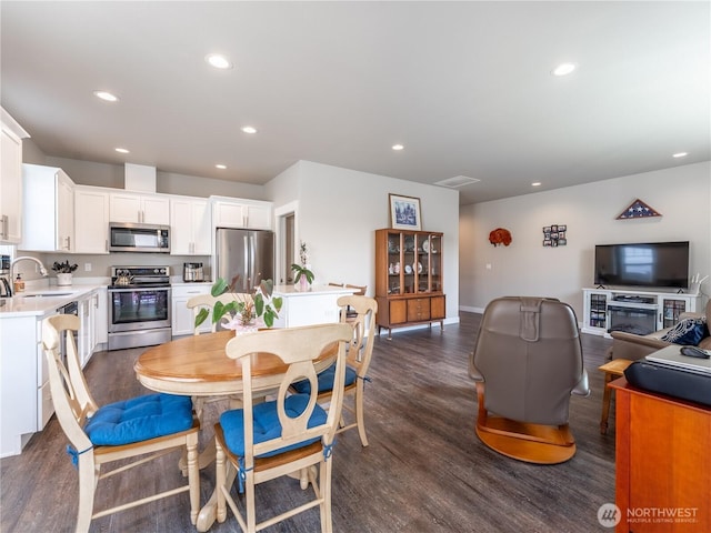 dining space featuring recessed lighting, dark wood-style flooring, and baseboards
