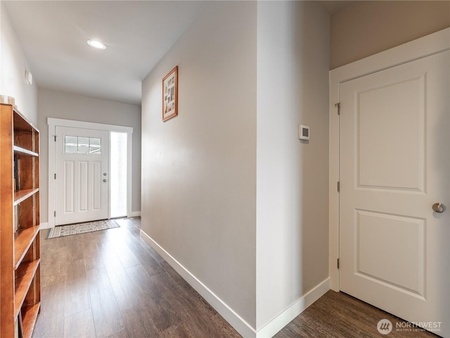 foyer featuring dark wood-style flooring, baseboards, and recessed lighting