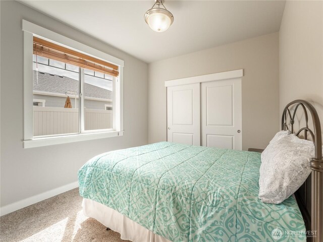 bedroom featuring baseboards, a closet, and carpet