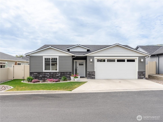 view of front of property with a garage, stone siding, and driveway