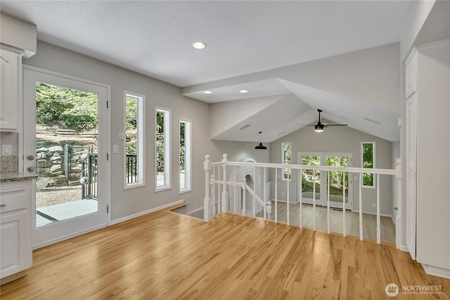 interior space featuring light wood finished floors, baseboards, a ceiling fan, and recessed lighting