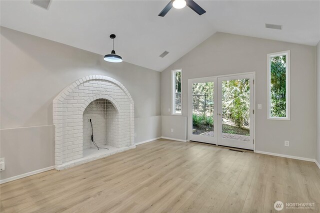 unfurnished living room featuring ceiling fan, visible vents, vaulted ceiling, and wood finished floors